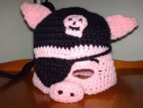 Crochet pig pattern for a Pirate Piggie Hat/Mask - perfect for fans who love all things swashbuckling and pig-related. Even better, it's free!